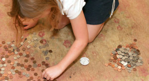 Schoolgirl learnimg about money