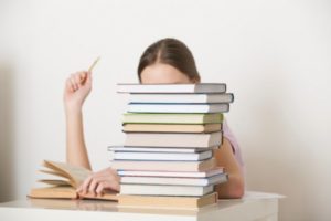 Woman Behind a Stack Of Books