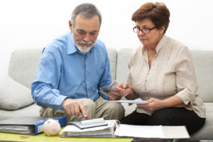 Retired couple calculating debt