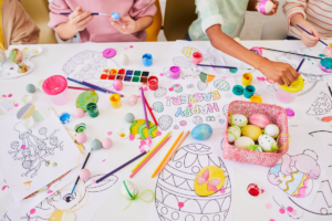 Children sitting at a table crating affordable crafts for Easter